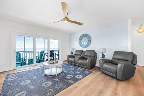 Relax in the modern living room with ocean views and balcony seating.