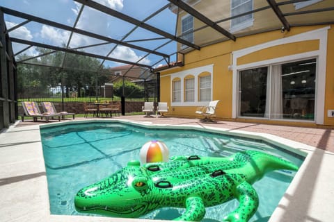 Dive into fun in our screened-in tropical courtyard pool-complete with a giant alligator float, beach ball, comfy loungers, and al fresco dining under the Florida sun!