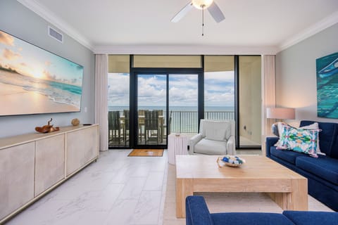 Unwind in the inviting living area, with cozy seating, queen sofa sleeper, large TV, and beachfront views