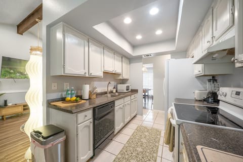 Fully functional kitchen. Stove, oven, fridge, coffee machine, and blender.