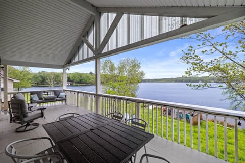 Covered upper-level deck with a seating area and outdoor dining table—ideal for meals with a view.