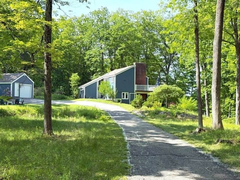 Our home and garage, nestled among lush greenery, welcome you from the private drive. Enjoy peaceful surroundings, natural light, and easy access to the lake for relaxation or adventure. A cozy retreat perfect for making memories in Connecticut.