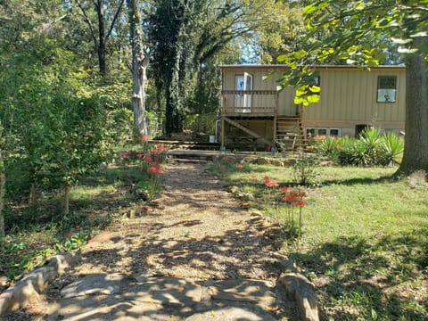 Back view. Wood deck, patio chairs, BBQ grill, table and chairs.