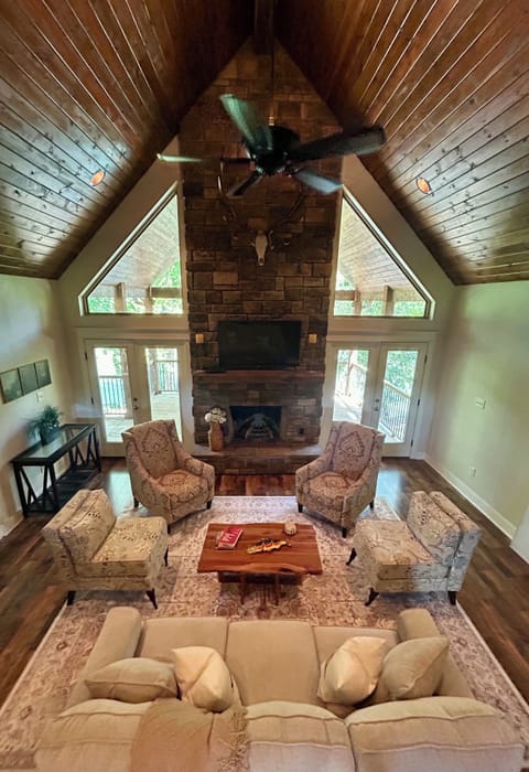 Living room with fireplace and riverfront view and queen sleeper sofa.
