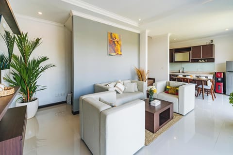 Cozy downstairs lounge with smart TV and sofas at Griya Purnama
