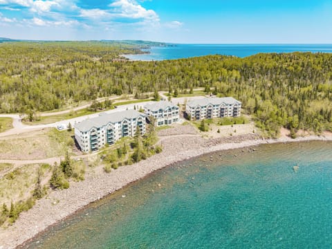 Lake Superior’s vastness meets cozy lakeside charm from above.