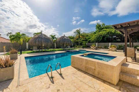 Enjoy ultimate relaxation by the poolside, with two shaded cabanas, lounge chairs, and a private hot tub. The serene atmosphere and lush surroundings provide the perfect setting for unwinding and enjoying the sunny weather.