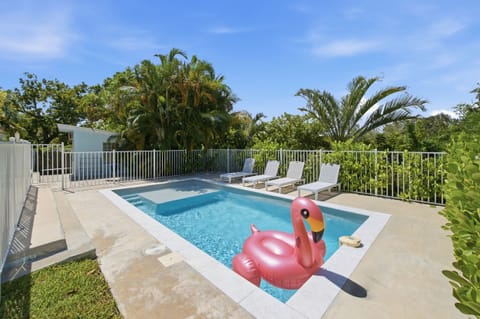 Sparkling private pool with lounge chairs and pool float