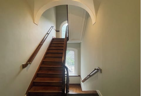 Well maintained staircase with wooden steps and handrails.