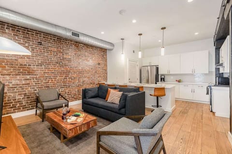 Open-concept living area featuring cozy furnishings, smart TV, and a sleeper sofa.