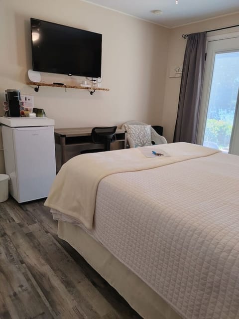 Room set up with workspace, mini fridge, keurig coffee/tea station, Roku TV