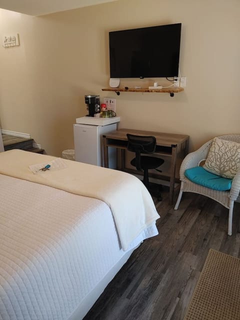 Room set up with workspace, mini fridge, keurig coffee/tea station, Roku TV