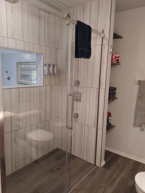 King Cove shower with shampoo, conditioner, & body was dispenser. Also a window into the sleeping area