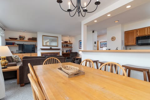 - Spacious dining table with seating for family gatherings - Open layout flows to living room and fireplace area - Bright inviting spot to share meals and conversations