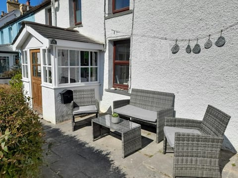 Glanrhaidr with seating area outside front of cottage