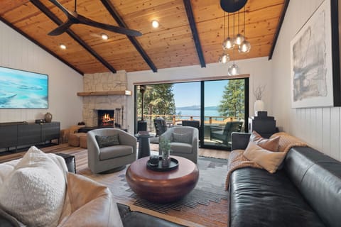 Living room with stacked door opening to deck