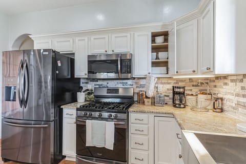 Stainless appliances and built-in pantry wall.