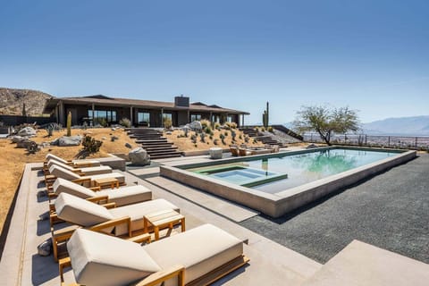 Elevated pool terrace with sweeping valley views and sun loungers.