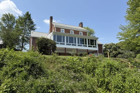 View of the back exterior and steps leading down to the lake