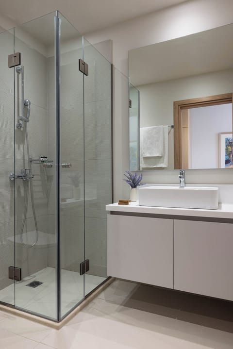 Shower, hair dryer, slippers, towels