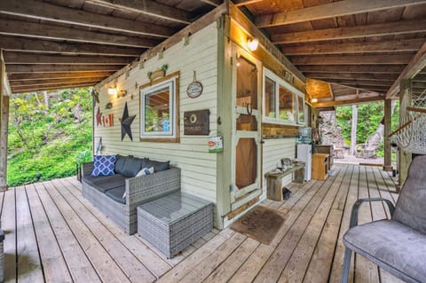 Unwind in the covered outdoor lounge with cozy wicker seating, ambient lighting, and a hammock. Rain or shine, this spot invites you to slow down and breathe in the forest air.