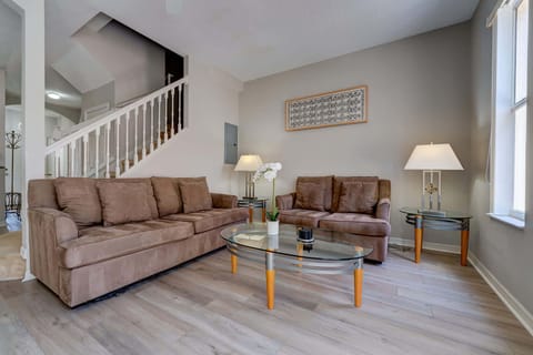 Living room with comfortable brown sofas and natural light from the window