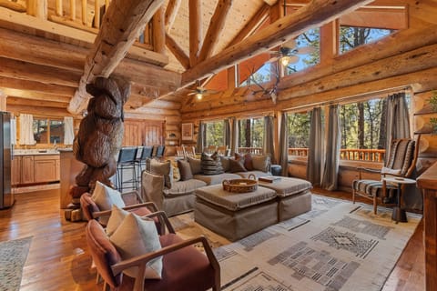 Spectacular great room with soaring windows, massive log beams, and unforgettable lodge style