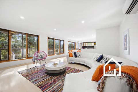 Located across from McCrae Beach is this colourful three level home