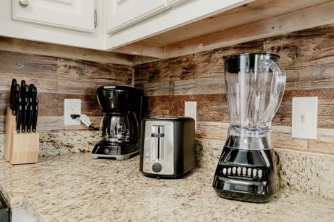 Fully-equipped kitchen includes a toaster and blender.