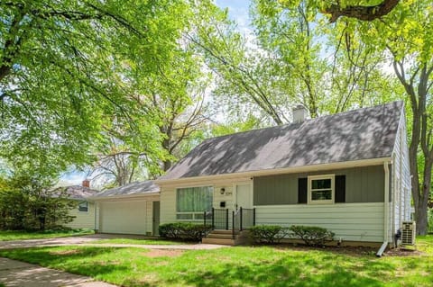 The exterior of the house features lush trees and a welcoming porch, creating a warm and inviting atmosphere for guests. A perfect spot to relax and enjoy the outdoors.