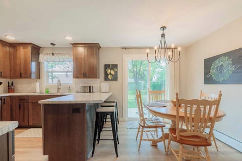Bright kitchen and dining area with sliding doors that open to a private back patio. Enjoy meals indoors or step outside for fresh air and outdoor dining.