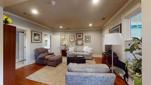 Open concept Den with a sleeper sofa, comfortable chairs and 4K Smart TV