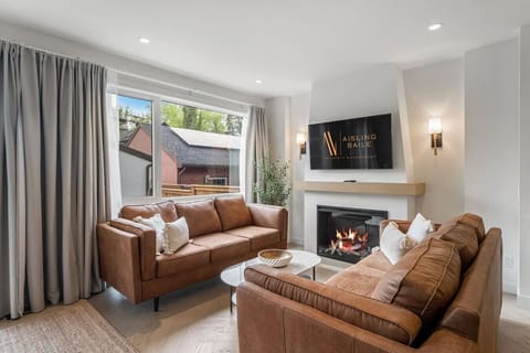 Living room with a fireplace, Smart TV, cozy seating & walkout access to the backyard.