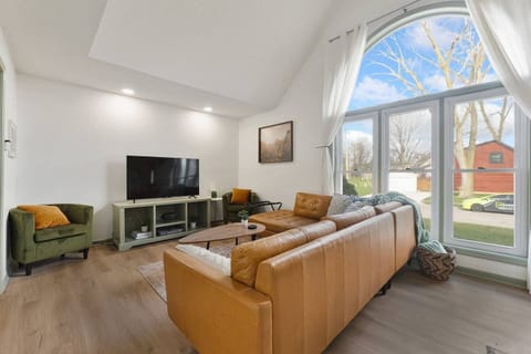 Natural light floods through the oversized statement window of this Indiana property. It is the ultimate spot to sip local coffee while watching the morning sun hit the quiet neighborhood.