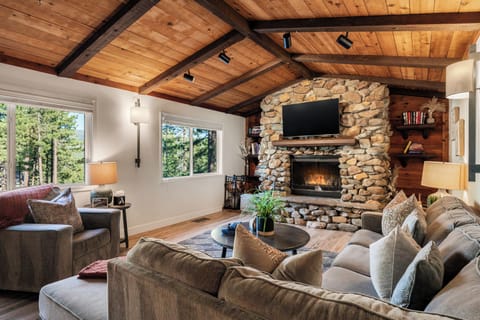 Cozy living area with comfortable seating, a fireplace, and a TV for relaxing nights in.