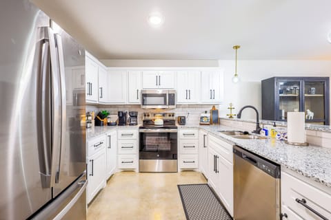 Modern kitchen with stainless steel appliances and granite counters.