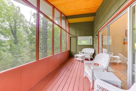 Screened in porch with patio furniture off living room.