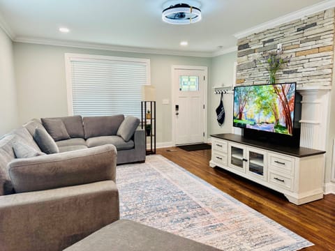Living room with large sectional and 55in Smart TV. 