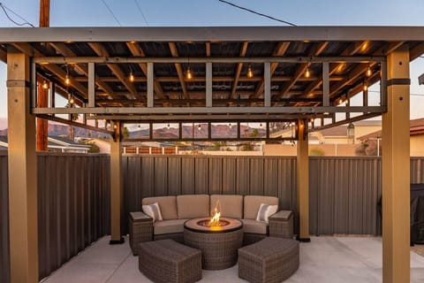 Cozy up under the backyard pergola with a built-in fire pit—perfect for evening hangs.