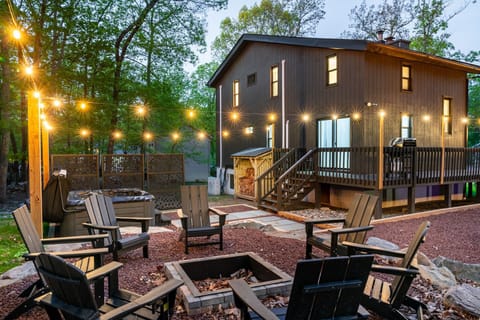 Spacious outdoor area with firepit and string lights.