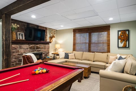 Fun game room with pool table, TV, and comfy lounge seating.