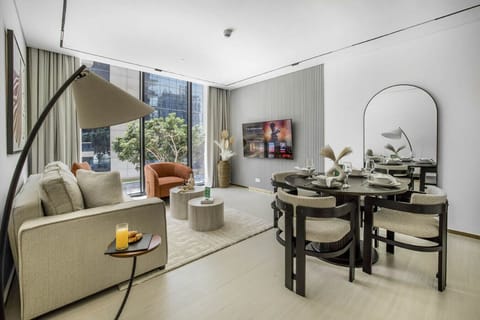 Open-plan living and dining area with a cozy sofa and smart TV