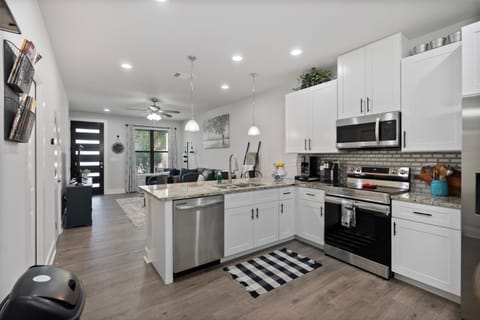 The open-concept layout connects the kitchen, dining area, and living spaces, making it easy for gatherings and socializing.