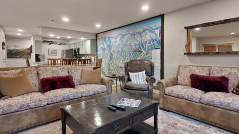 Cozy living area with ski trail mural