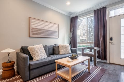 Stylish living area with plush seating, elegant décor and natural light.