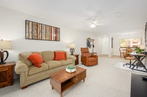 Large open and clean living room with leather recliner.