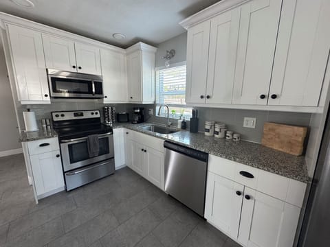 updated kitchen with cooking staple (salt/pepper, oil/vinegar & spices)