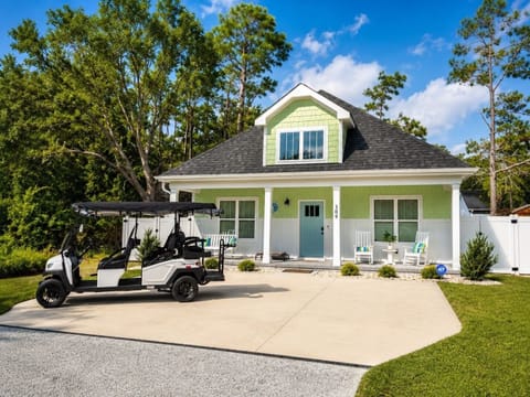 Charming cottage with front porch seating and golf cart parking