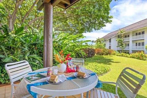 Al fresco lunch on the shaded lanai at Kiahuna Plantation 324 — surrounded by tropical greenery and island sunshine.