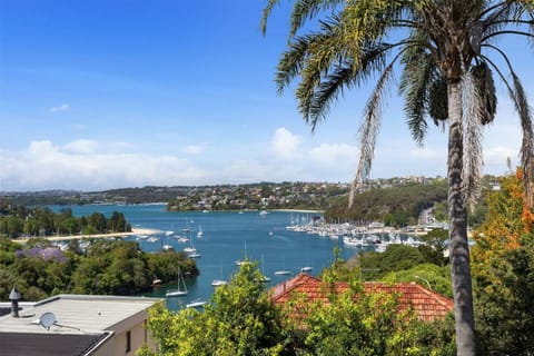 Elevated exterior view of the property showcasing water views and surrounding greenery.